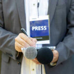 Navy SEAL SLAMS Candidate’s ‘Barbaric’ Soldier Comment… Press member holding microphones and taking notes.