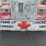 Alberta’s Secession: Will Canada COLLAPSE? Front of truck with Stand Up Canada Truckers Unite.