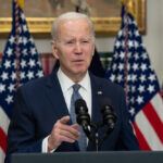 Biden Fights Hard to HIDE Ghostwriter Audio! Man speaking at podium with American flags behind