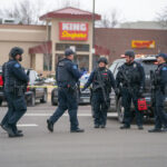 Toxic Crisis: LOOTERS Strike Evacuation Zone! Police officers gathered outside King Soopers grocery store.