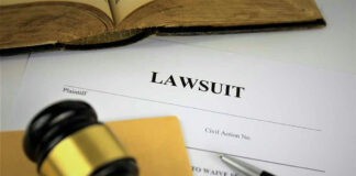 Lawsuit documents with gavel and pen.