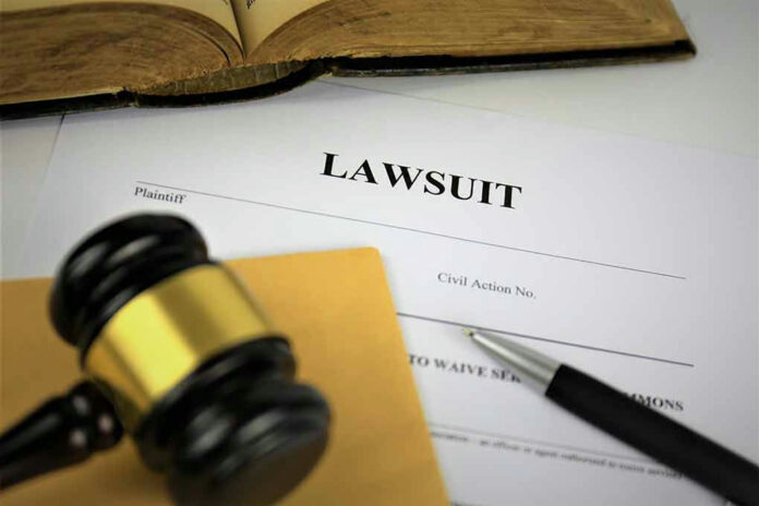 Lawsuit documents with gavel and pen.