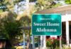 Trump-Endorsed Secures Senate Nomination Green roadside sign reading Welcome to Sweet Home Alabama near a building and trees