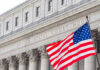 Judge SCANDAL Explodes — SHE Kept Her Robe! United States courthouse with American flag waving.