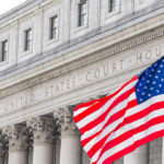 Judge SCANDAL Explodes — SHE Kept Her Robe! United States courthouse with American flag waving.
