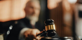 Judge's gavel striking a sound block in a courtroom