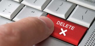 finger pressing red keyboard key labeled erase past
