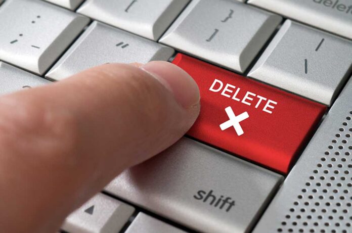 Business,Concept,Male,Finger,Pointing,Delete,Key,On,A,Metallic finger pressing red keyboard key labeled erase past