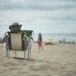 Person sitting in a beach chair overlooking the ocean