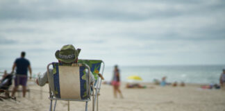 Person sitting in a beach chair overlooking the ocean