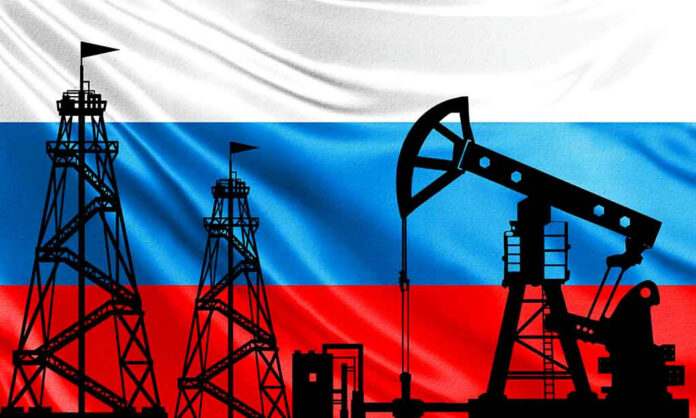 Silhouettes of oil rigs on Russian flag background.