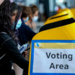 People voting at a polling station.