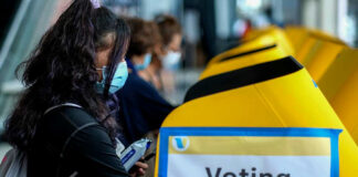 People voting at a polling station.