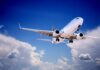 Airline Seat Dispute Turns Violent Midair Commercial airplane flying with landing gear extended against a blue sky