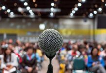Constitutional Showdown Looms In Los Angeles Microphone on stage facing a blurred audience