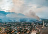 Toxic Haze Chokes 100 Million Aerial view of wildfire smoke over suburban town.