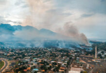 Toxic Haze Chokes 100 Million Aerial view of wildfire smoke over suburban town.