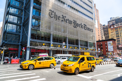 Busy street scene in New York City with yellow taxis and The New York Times building