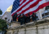 Washington Guard Mission Tested In Court Police in riot gear near U.S. Capitol building.