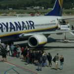Passengers boarding a Ryanair plane at the airport.