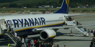 Passengers boarding a Ryanair plane at the airport.