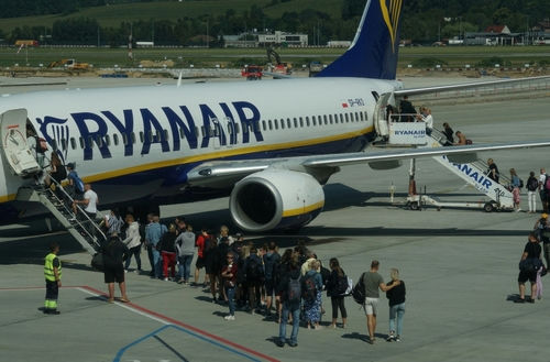 Passengers boarding a Ryanair plane at the airport.