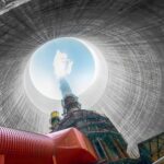 View from inside a cooling tower of a power plant, showing smoke and blue sky