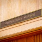 Governor's Office sign above a wooden doorway