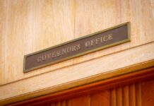 Virginia Voters Turn Against Governor Early Governor's Office sign above a wooden doorway