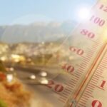 Germany’s Hottest Week Turns Lethal Close-up of a thermometer in hot sun over a blurred road and mountains