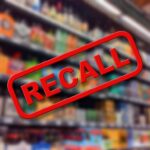 Recall notice over blurred store shelves.