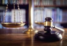 Scales of justice and gavel in courtroom.