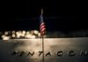 American flag on Pentagon memorial at night.